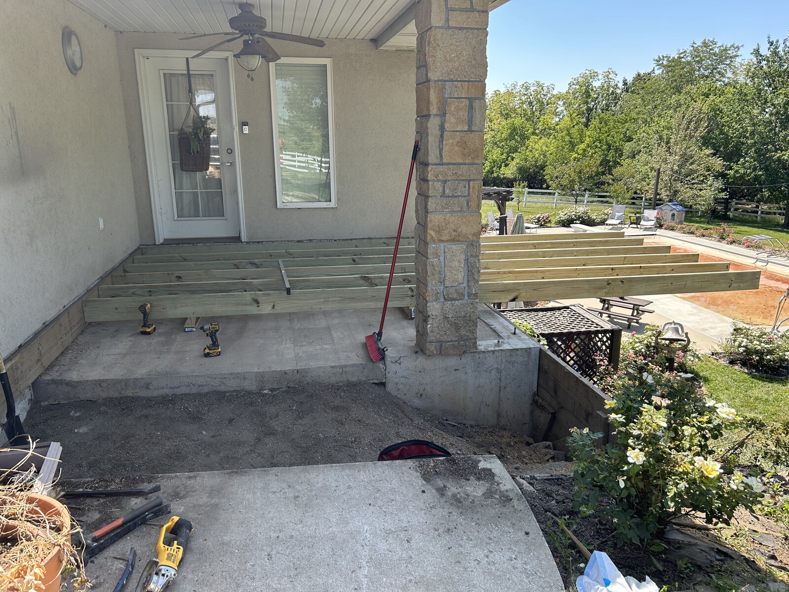 Exposed deck framing beside the covered patio.