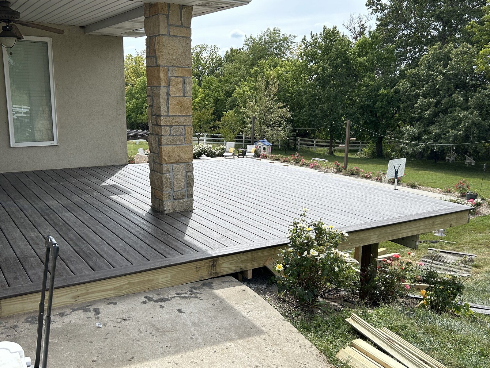 Deck boards fitted around the existing patio column.