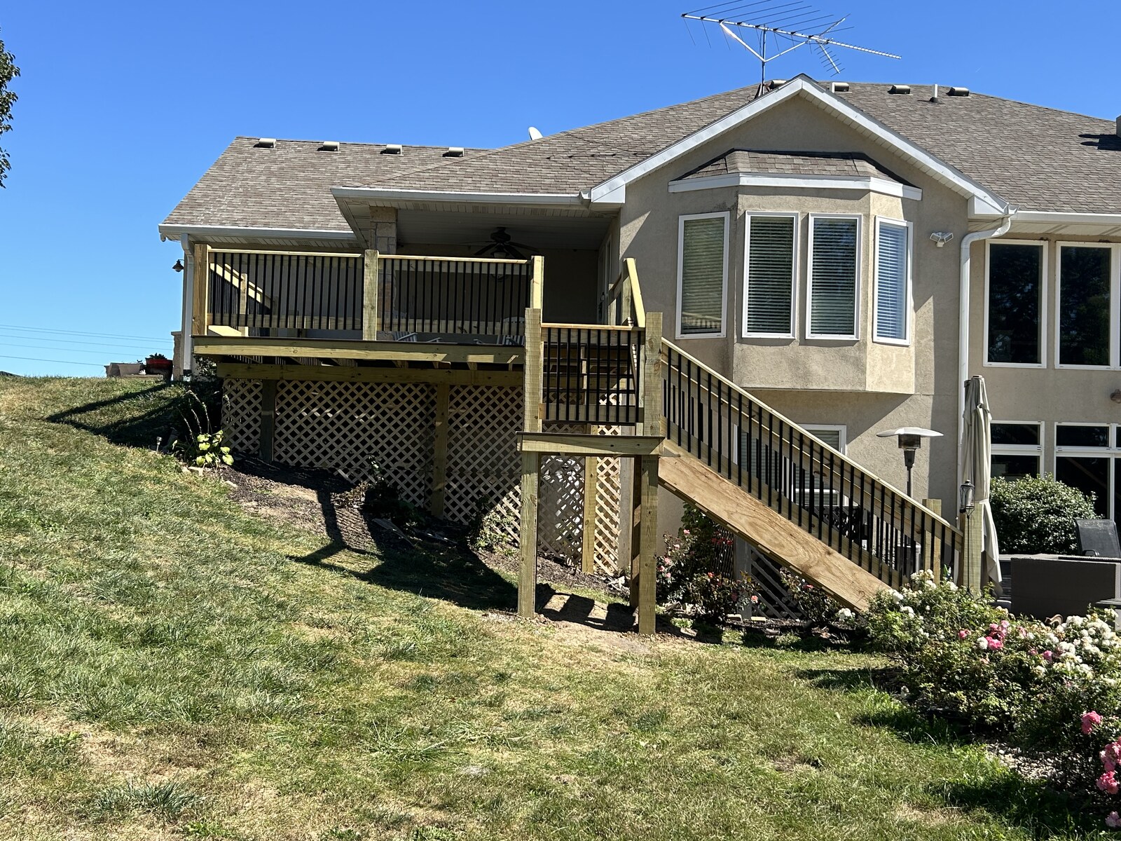 Overall view of the deck, two stair flights and finished railings.