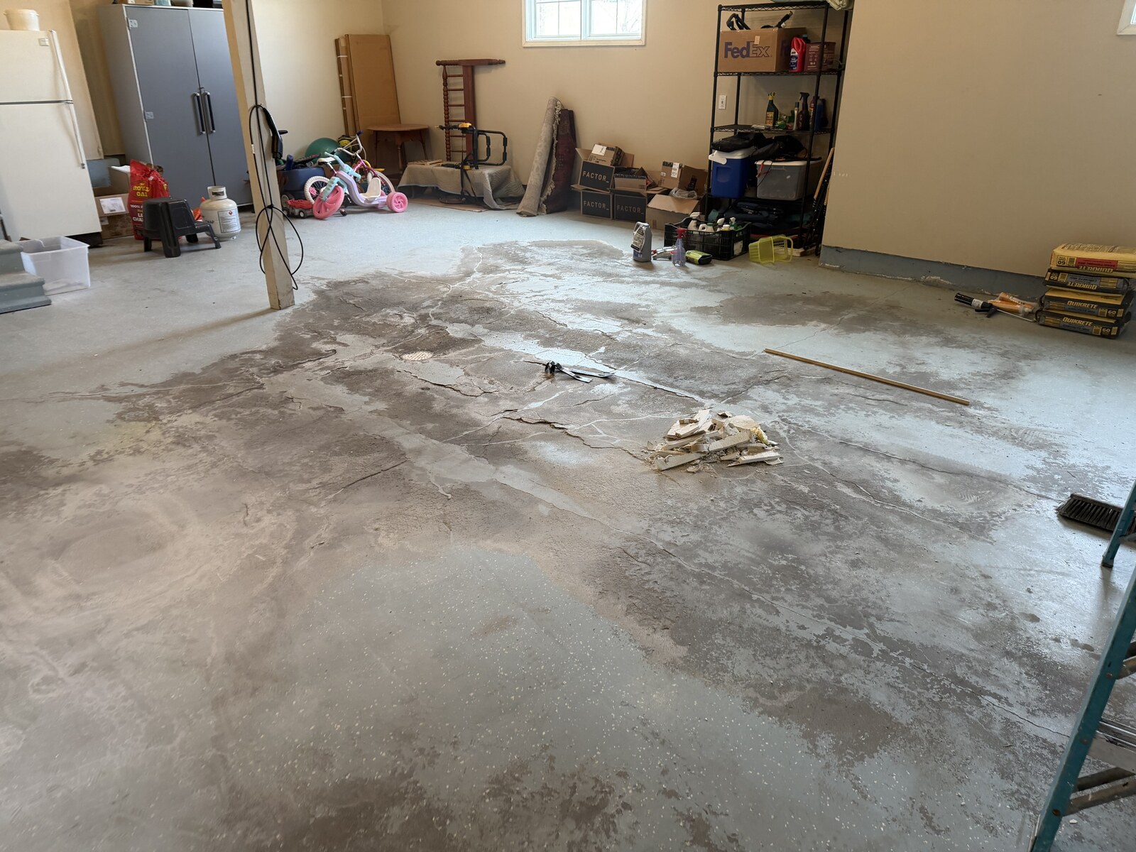 The garage floor at the start of the documented refinishing work.