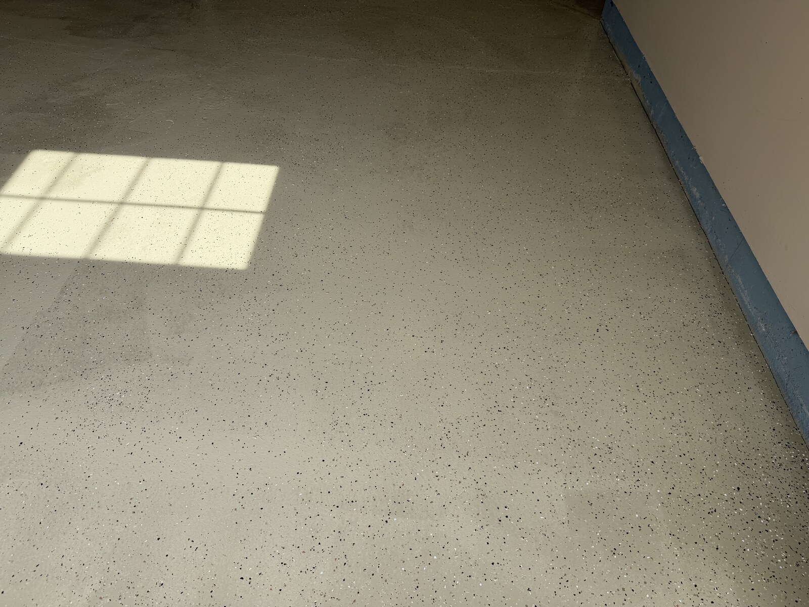 Speckled finish detail beside the garage wall.