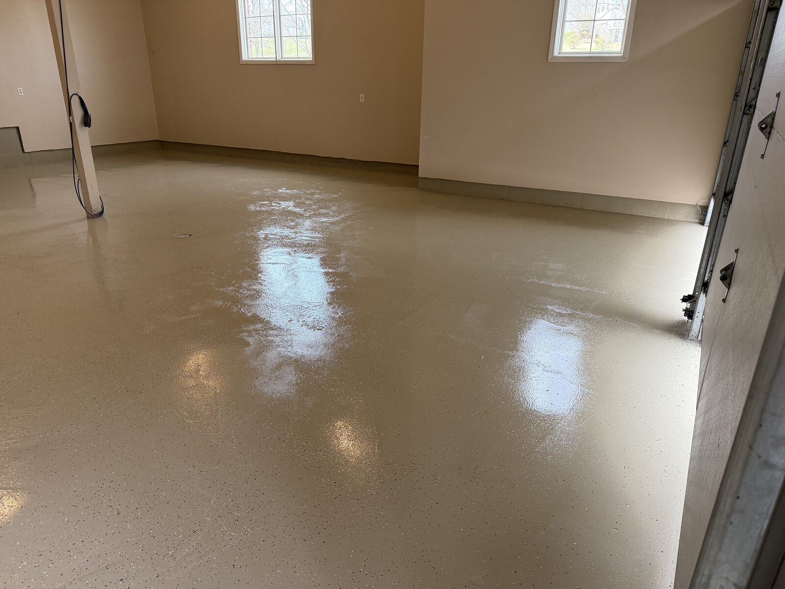 Glossy floor finish viewed toward the garage windows.